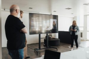 Business team engaged in a corporate presentation in a modern office space.